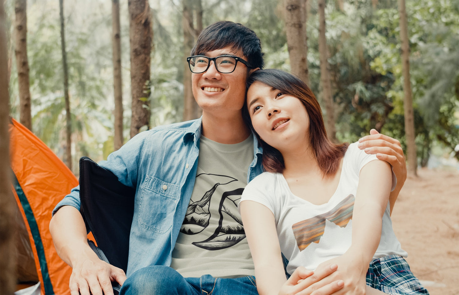 happy couple camping wearing slowpoke maniac adventure theme shirts