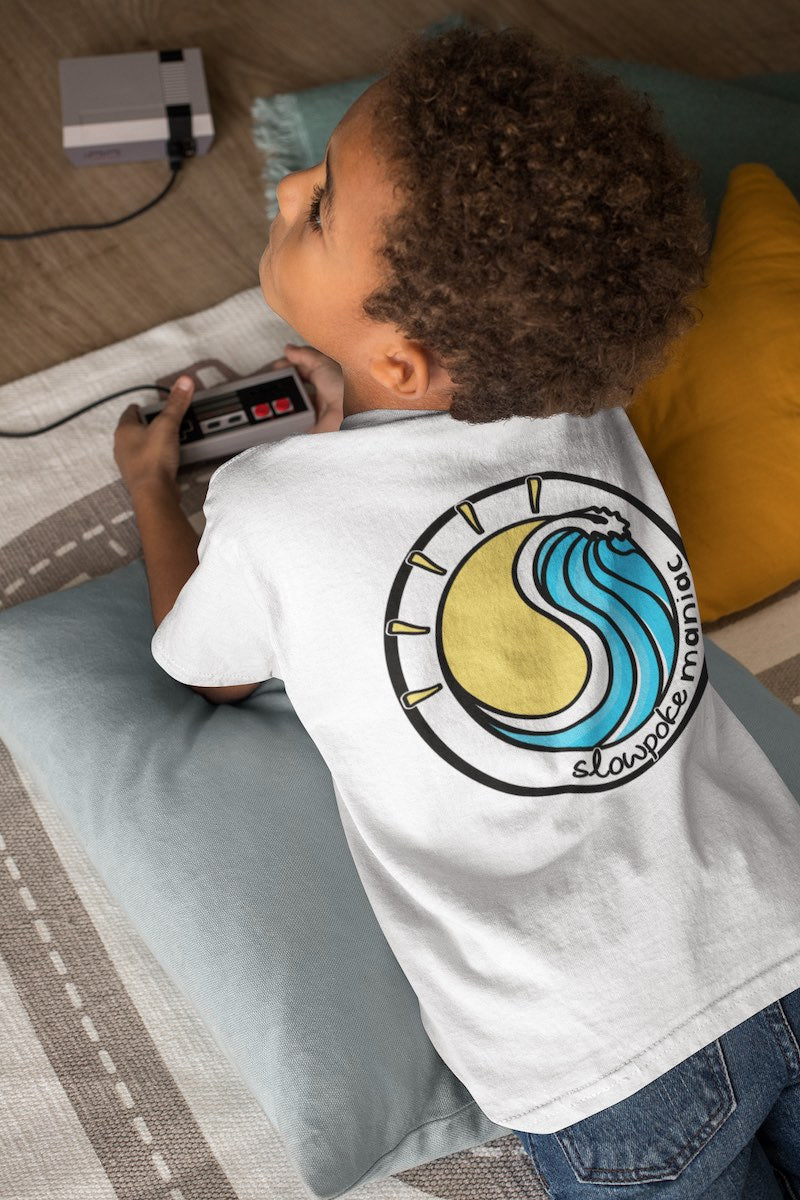 young boy wearing a slowpoke maniac 'beach life' shirt while gaming